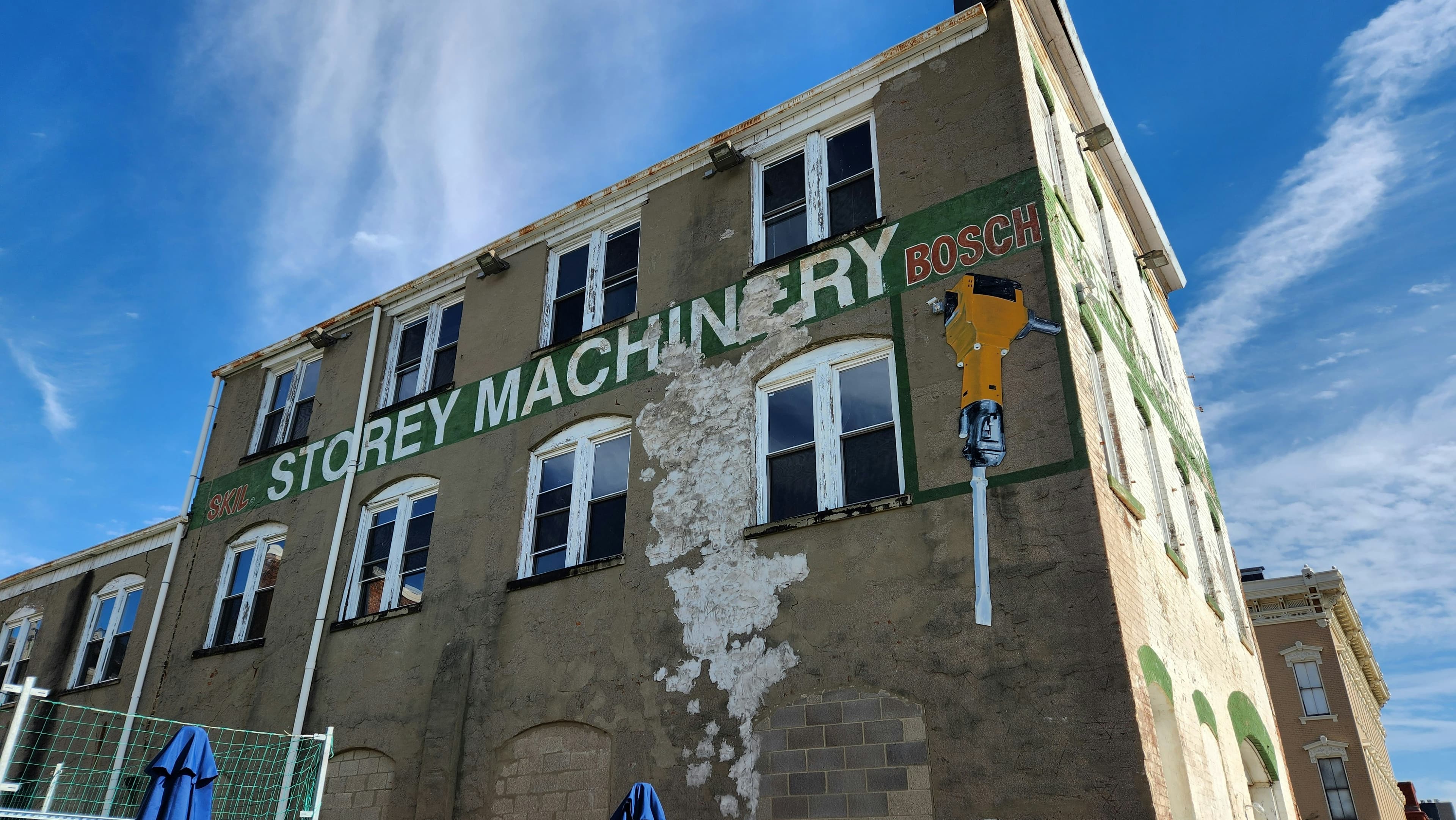 Historic Midwest industrial building with 'Storey Machinery' signage